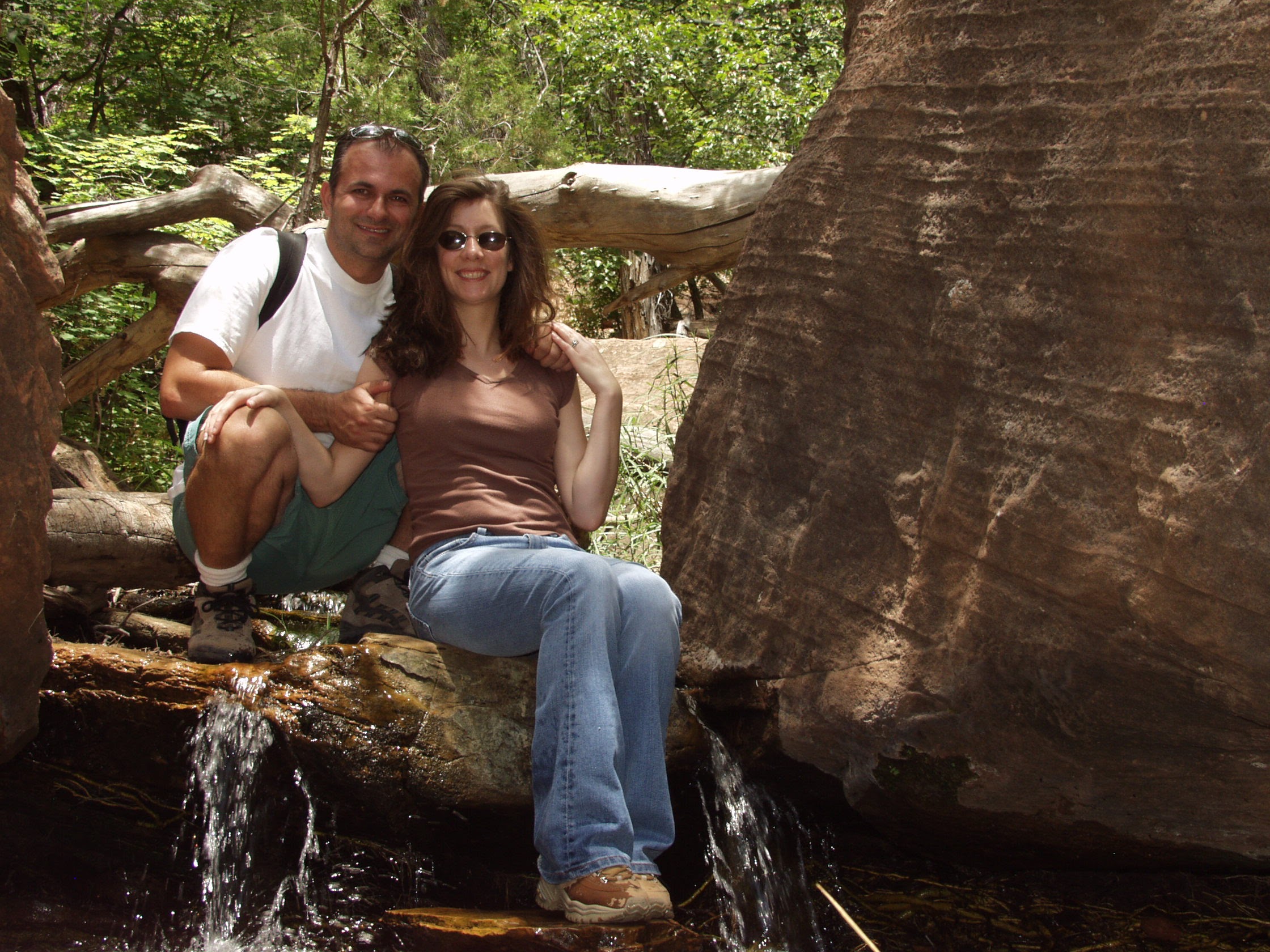 Themio and Christian by a creek and sandstone wall, June 2004