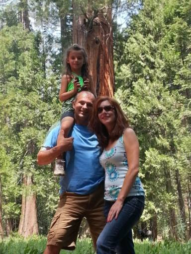 Themio and Christian with Yiannoula holding pine cones in the redwoods
